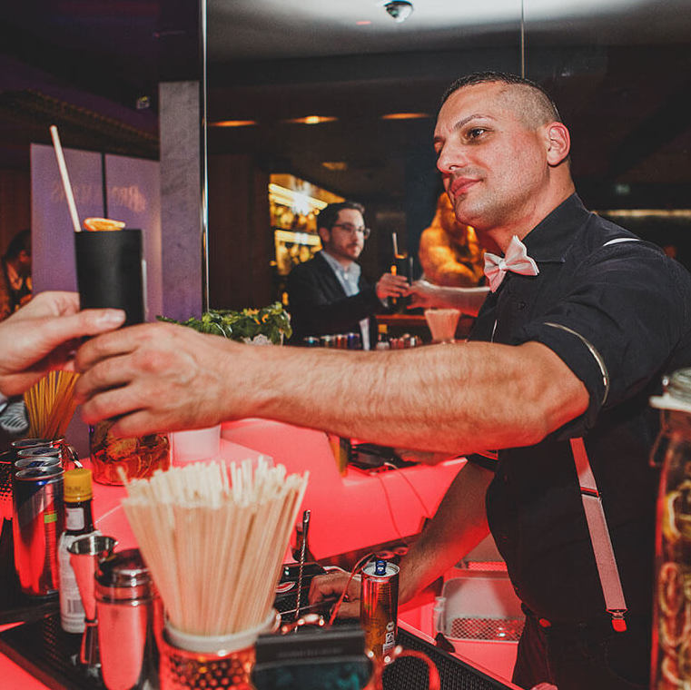 Barkeeper übergibt Cocktail an Kunde im THE NEW GRACE